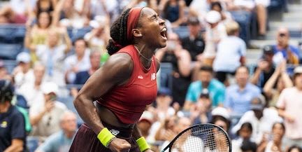 Coco Gauff celebrating a point on court, racquet in hand